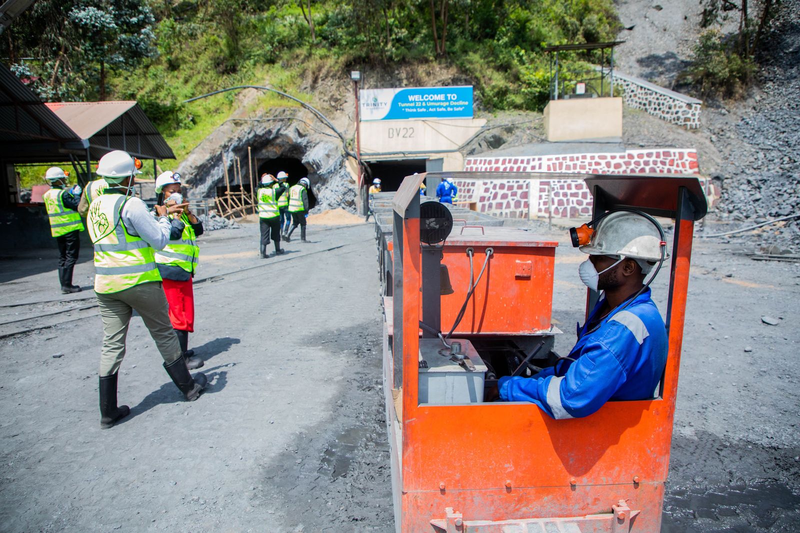 Mining team in safety equipment at a mine entrance